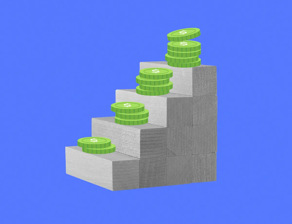 4 wooden blocks simulating steps with stacks of green coins on top of them.