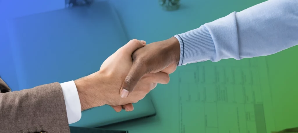 Two different hands doing a handshake alluding to supply chain relationships. 