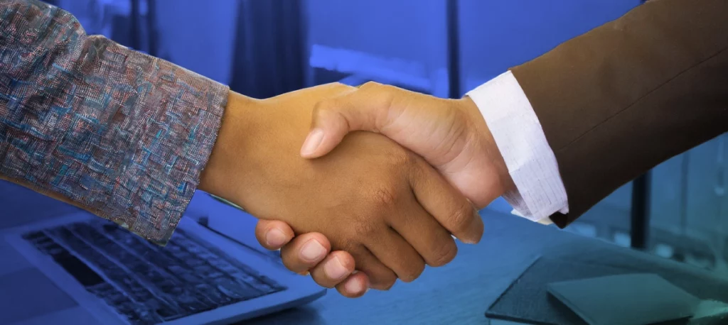 Two hands doing a handshaking alluding to closing a deal or maintaining a business relationship for banking for startups.