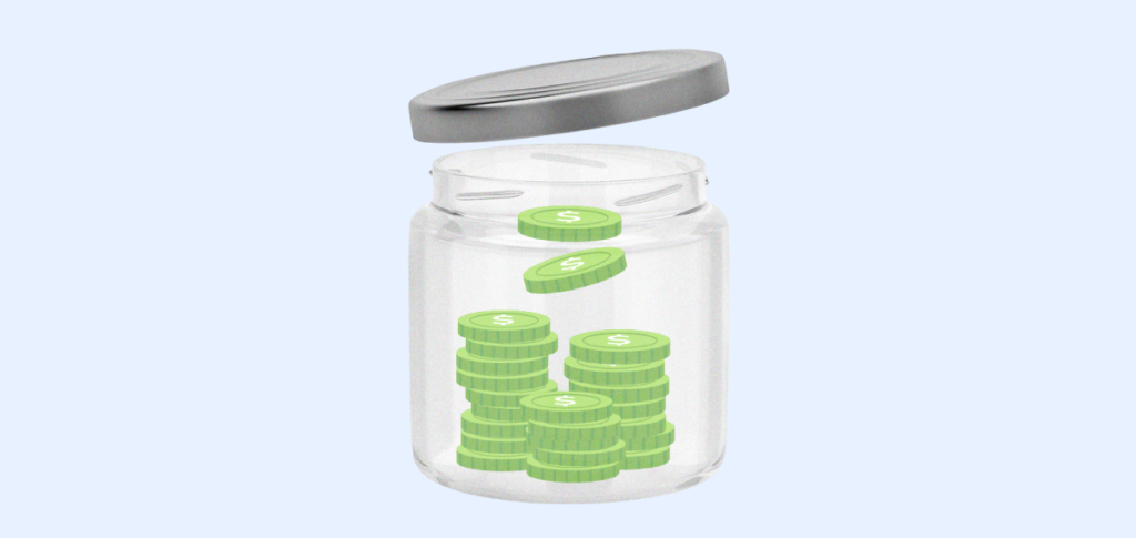 A glass jar filled up with some green coins. 