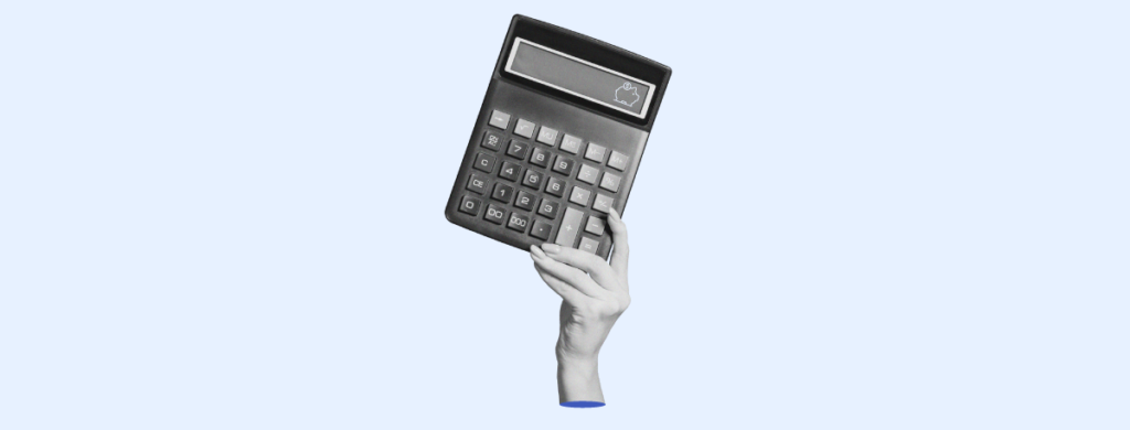 A hand holding a calculator. 