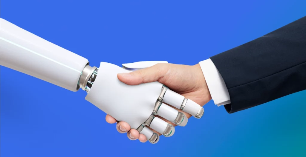 A human hand making a handshake with a robot hand alluding the technological advancements meeting. 