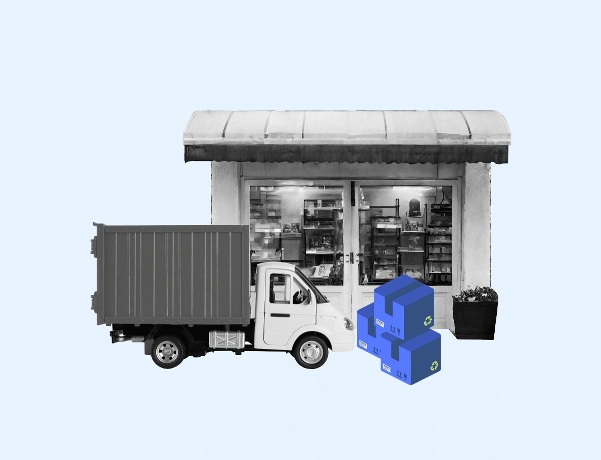 A grayscale image illustrating a retail delivery scenario. A delivery truck is parked in front of a small shop, with its rear doors open towards the store. Beside the truck, there are three blue boxes with currency symbols, stacked in a pyramid shape, indicating goods or packages ready for shipment or delivery.