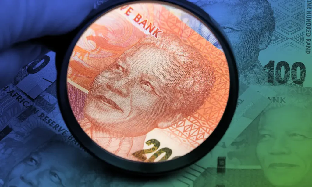 A closeup to South African currency, highlighting a 100 Rand note through a magnifying glass, which brings into focus the portrait of Nelson Mandela.
